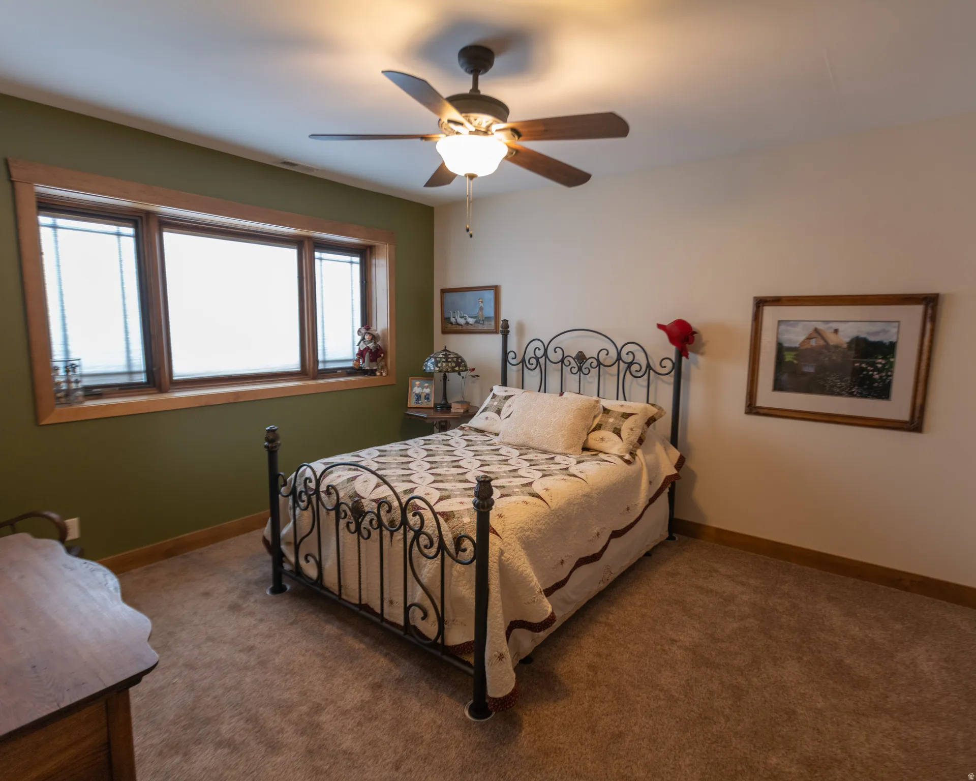 Bedroom featuring a ceiling fan and carpet