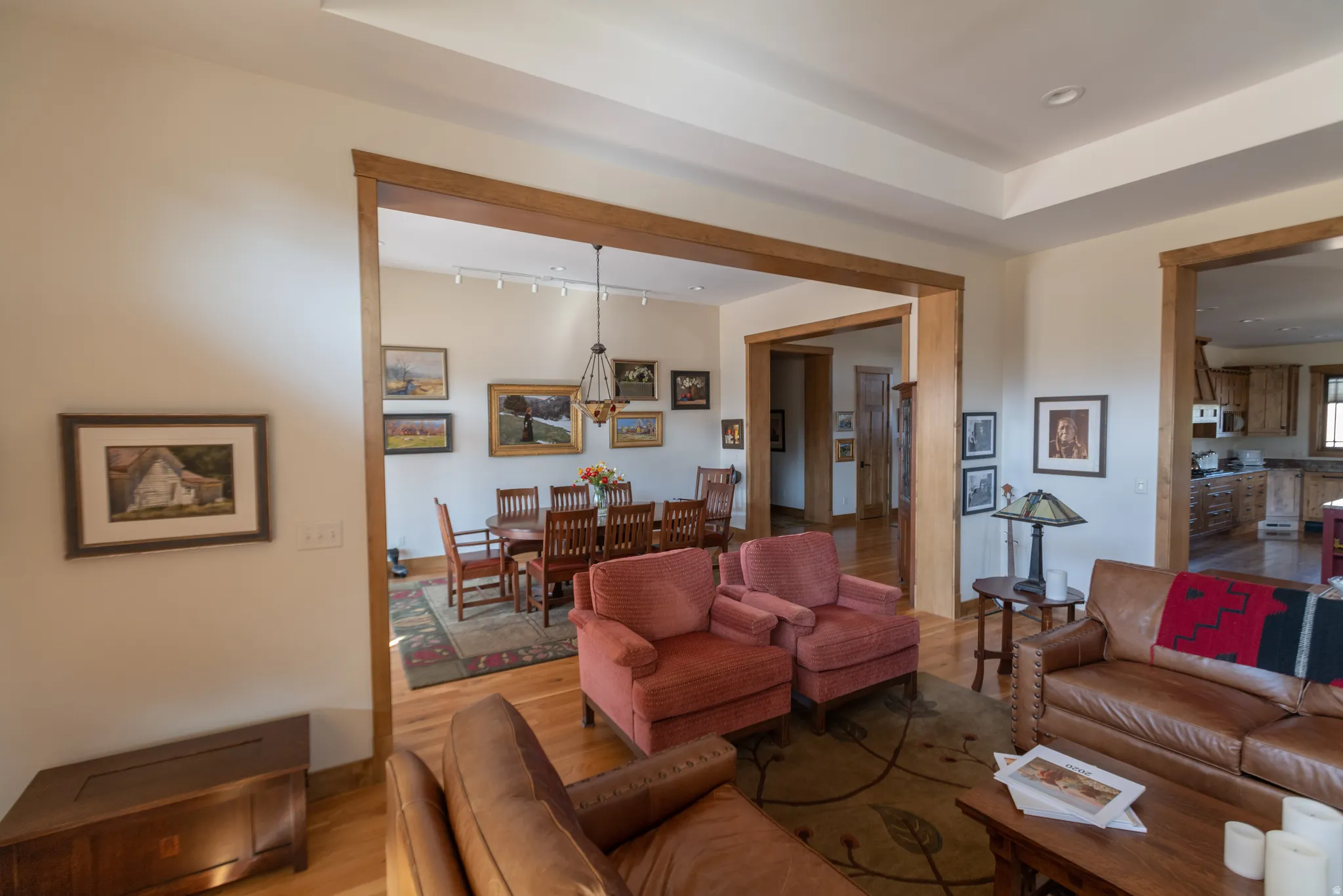 Living area with wood finished floors and track lighting