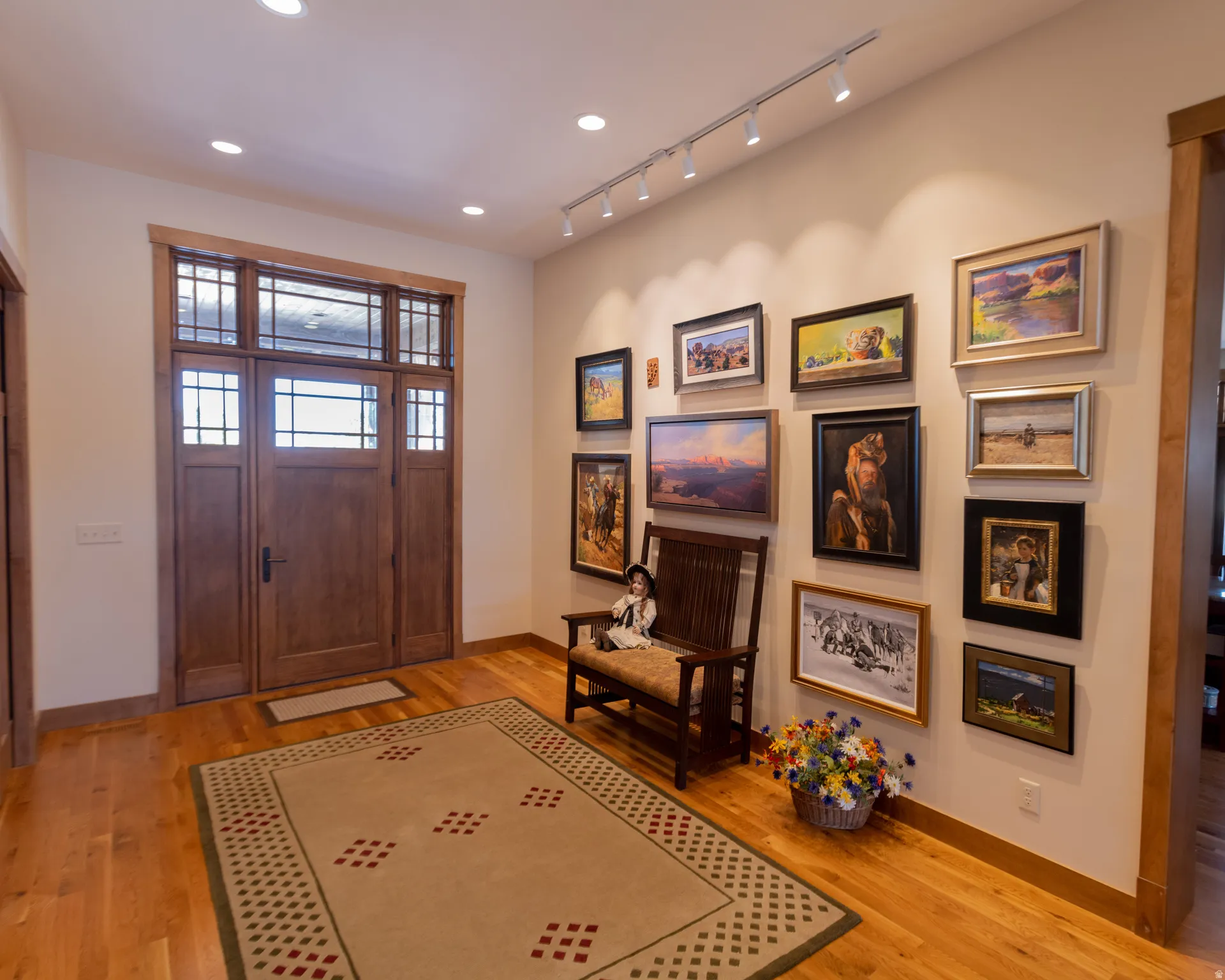 Foyer entrance with light wood finished floors and rail lighting