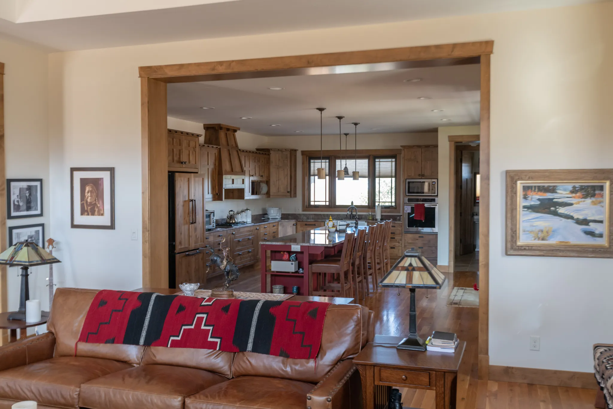Living room with light wood finished floors and recessed lighting