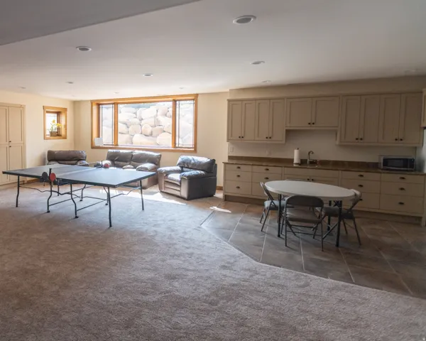 Recreation room featuring light carpet and recessed lighting
