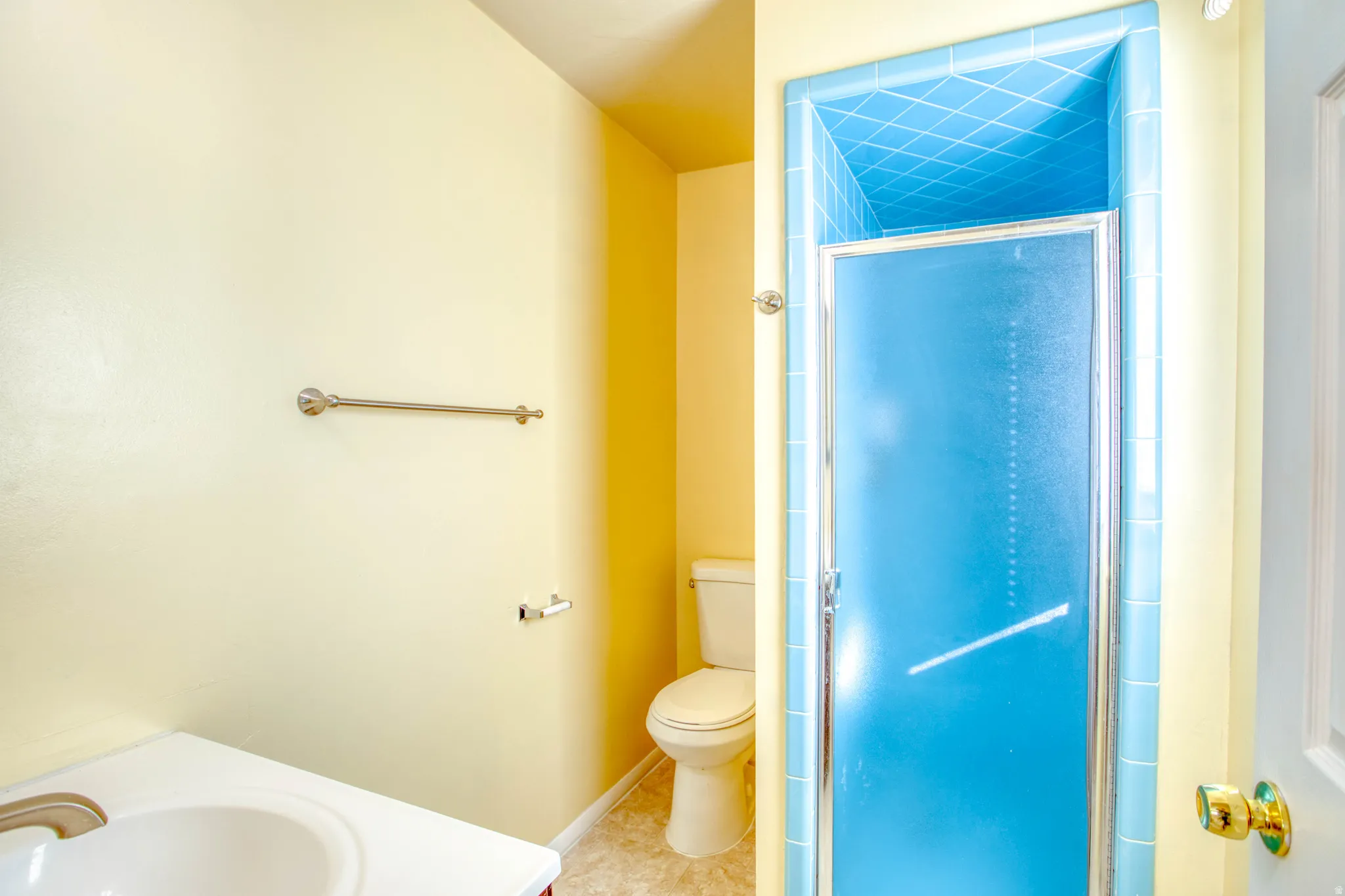 Bathroom with vanity, a stall shower, and tile patterned flooring