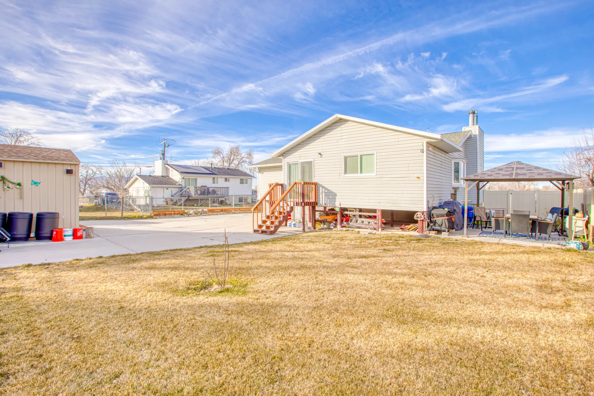 Back of house featuring a patio area, a residential view, and a gazebo