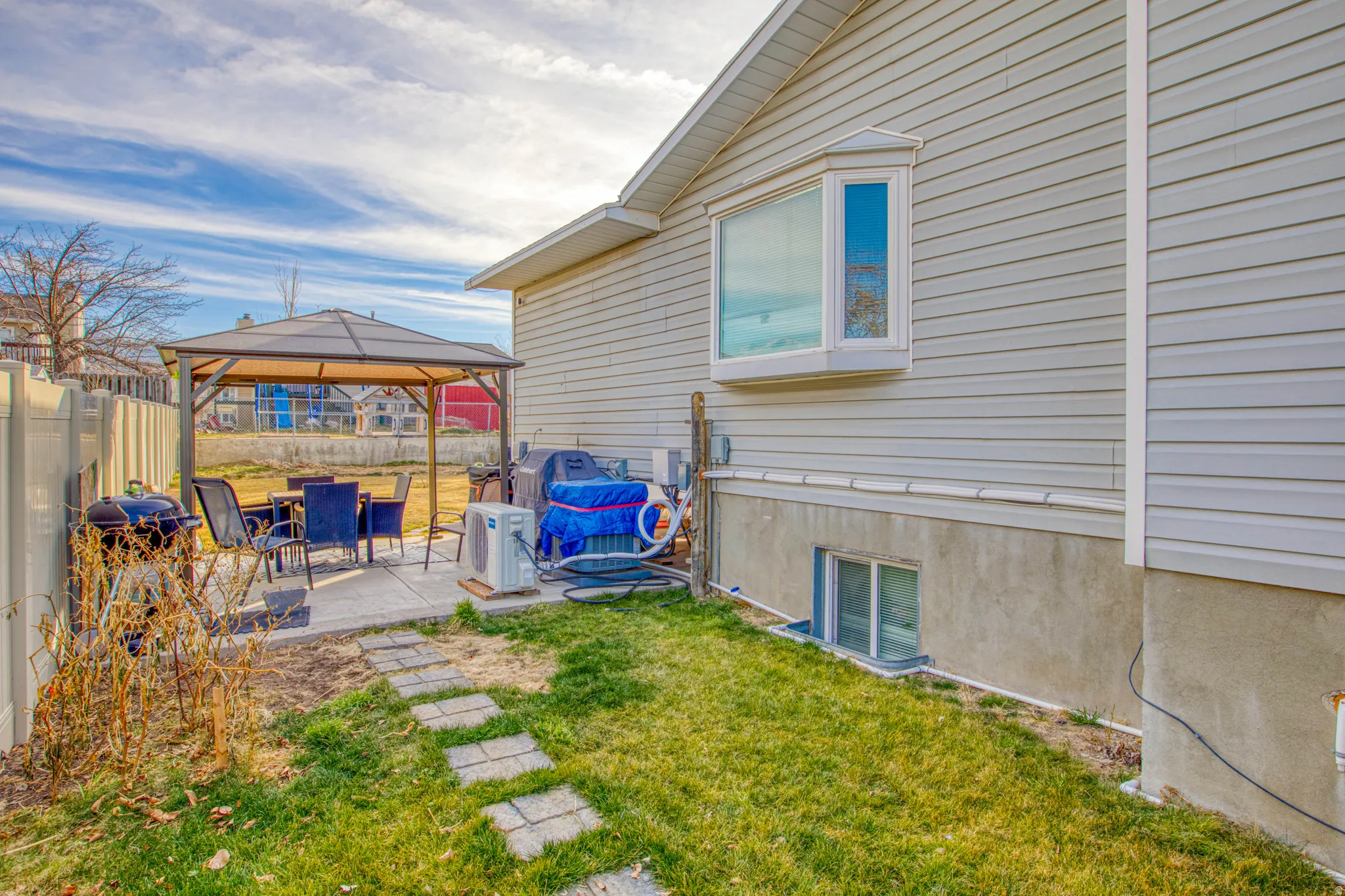 Fenced backyard with a gazebo and a patio
