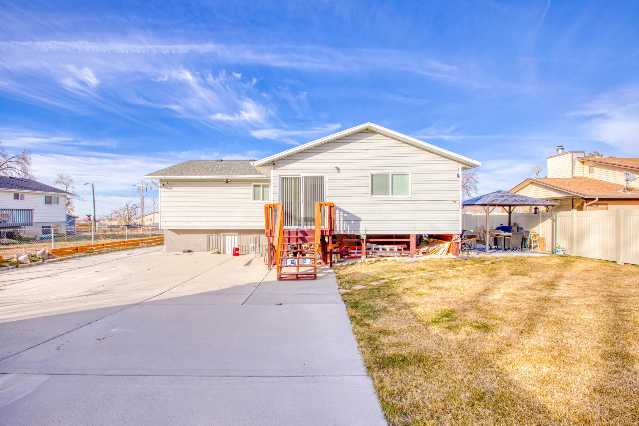 Back of property with a gazebo and a patio area