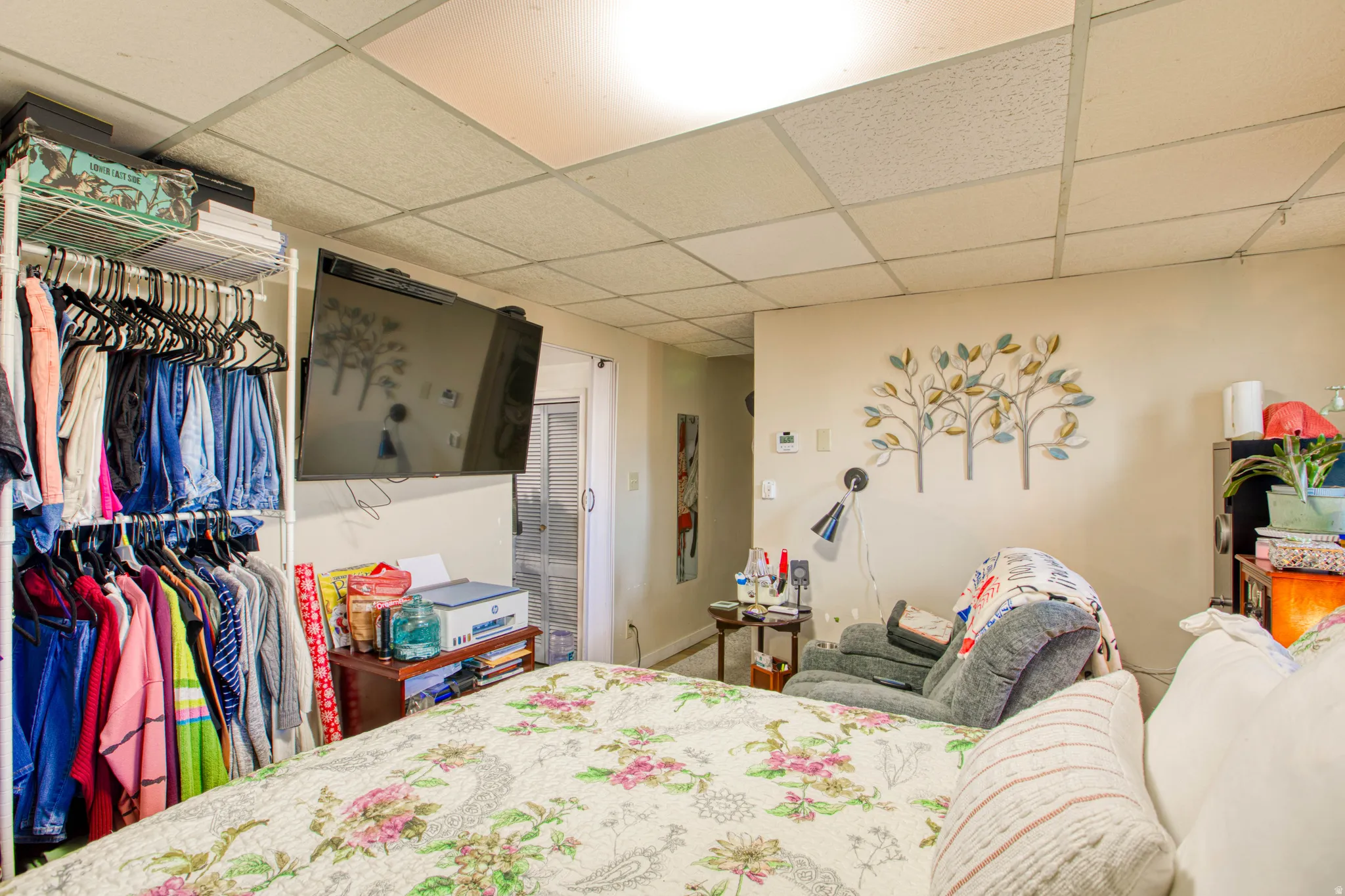 Bedroom with a drop ceiling and a closet