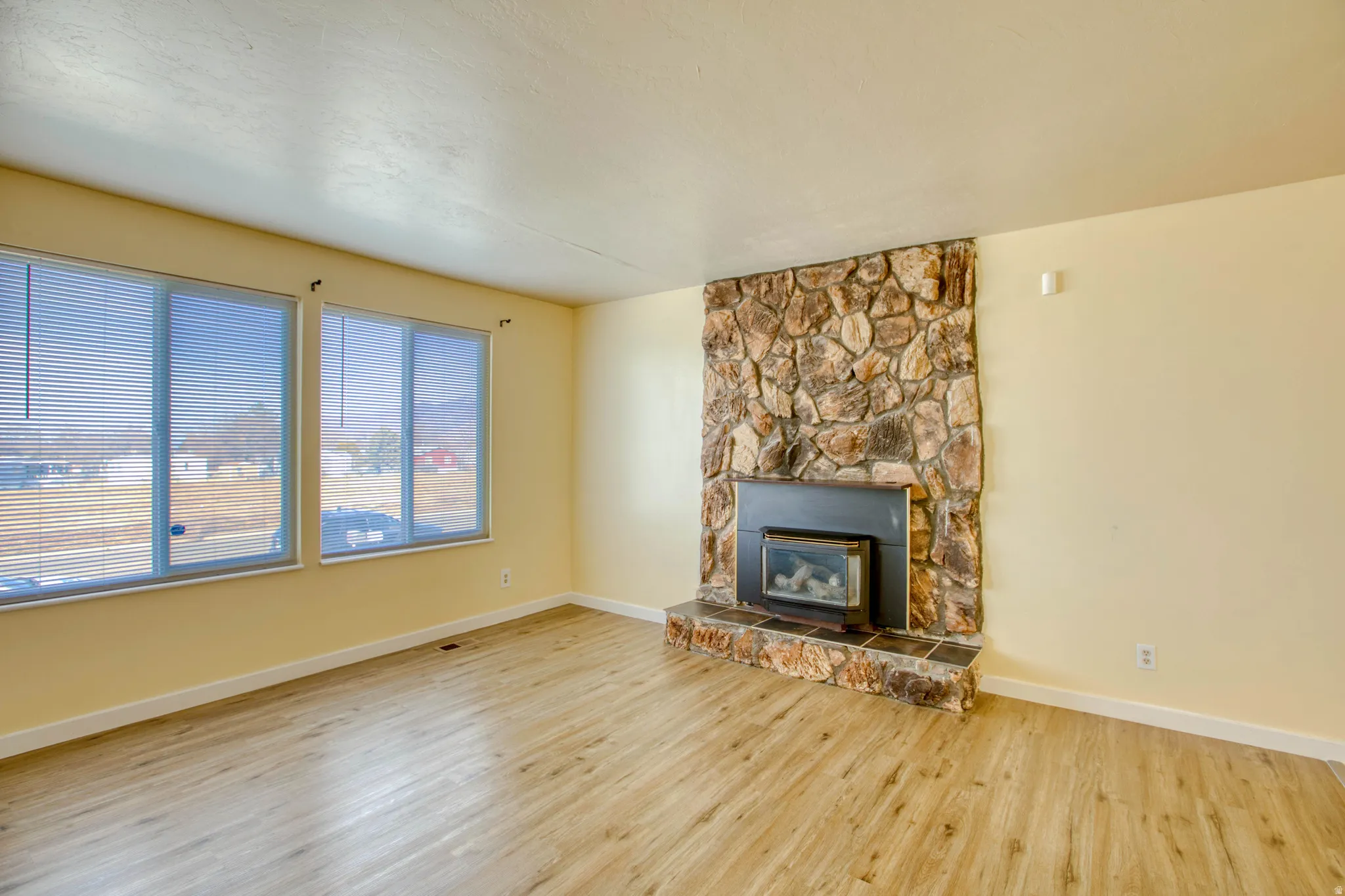 Unfurnished living room with a fireplace and wood finished floors