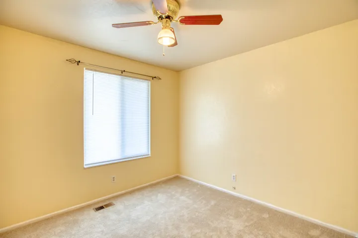 Spare room with carpet floors and ceiling fan