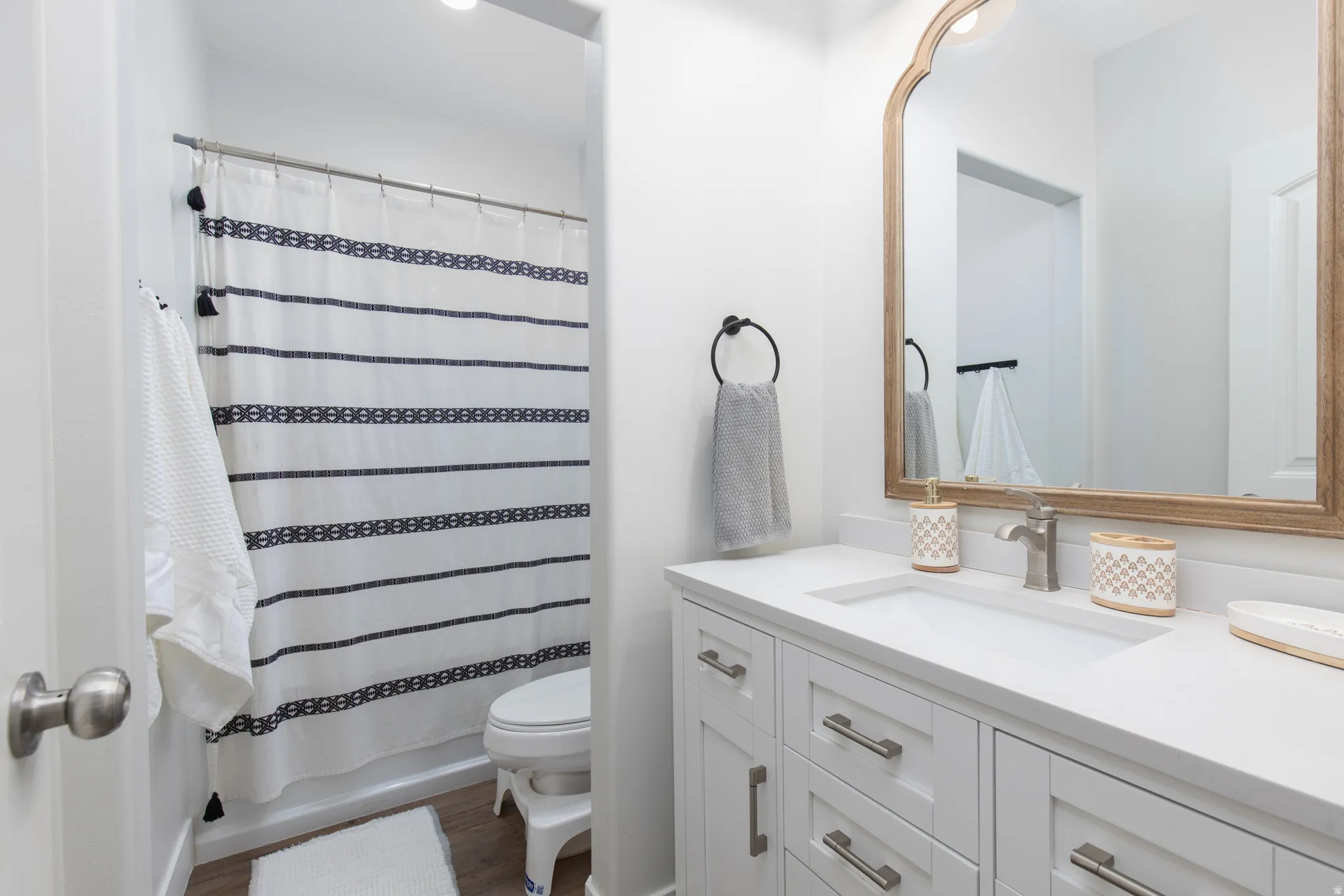 Bathroom with vanity, dark wood-type flooring, and shower / tub combo