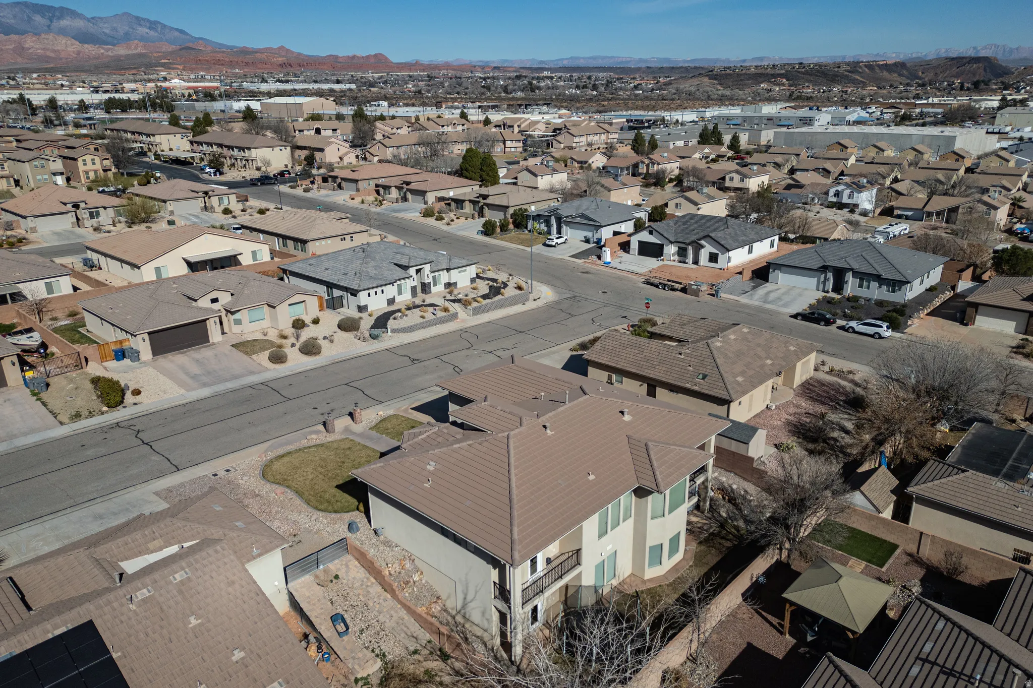 Aerial view of property's location with nearby suburban area and mountains