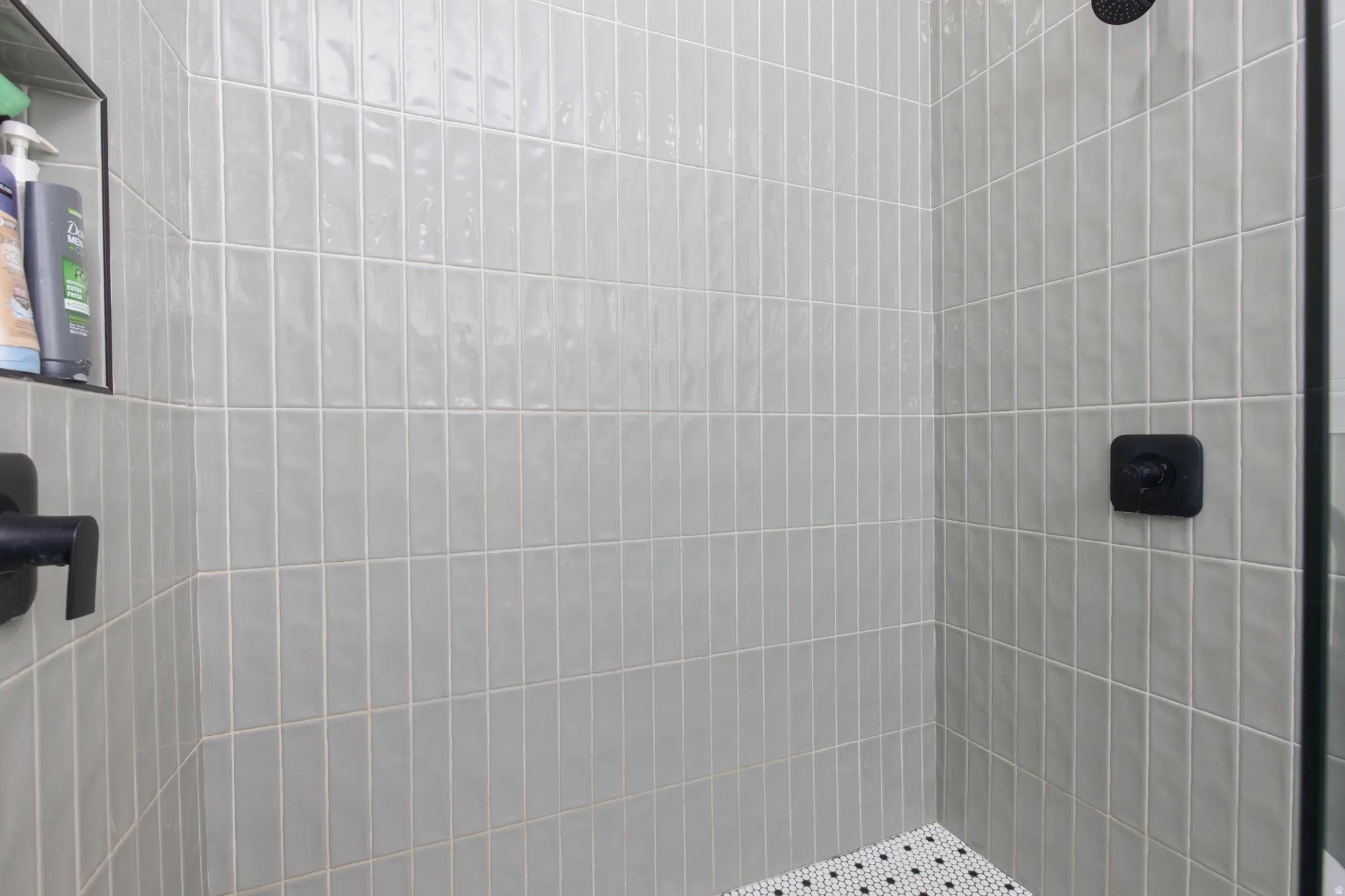 Full bath with a tile shower