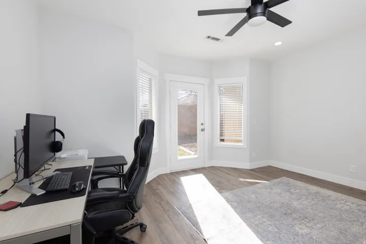 Home office featuring light wood-style floors, ceiling fan, and recessed lighting