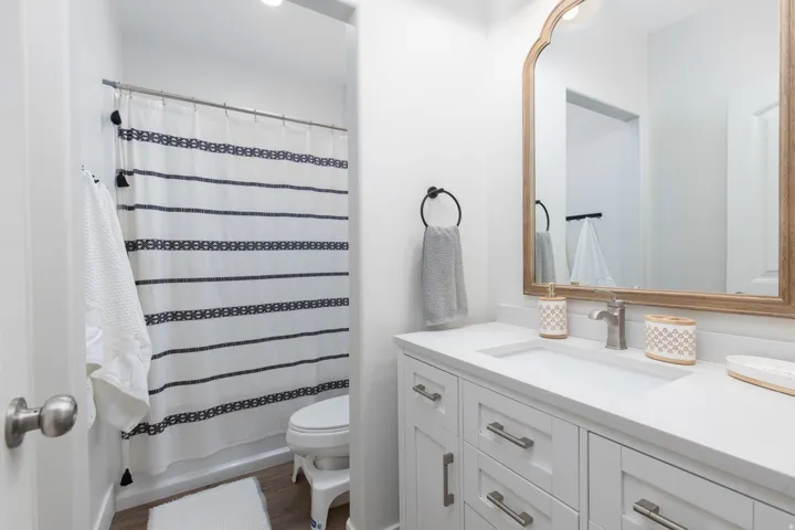Bathroom with vanity, dark wood-type flooring, and shower / tub combo