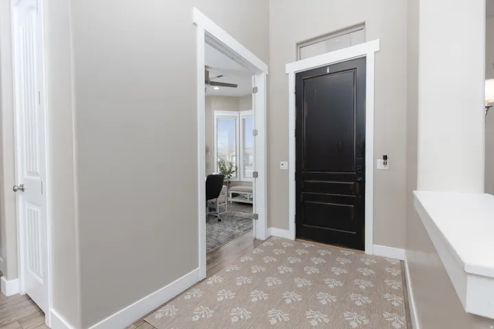 Foyer entrance featuring a ceiling fan and light wood-style flooring