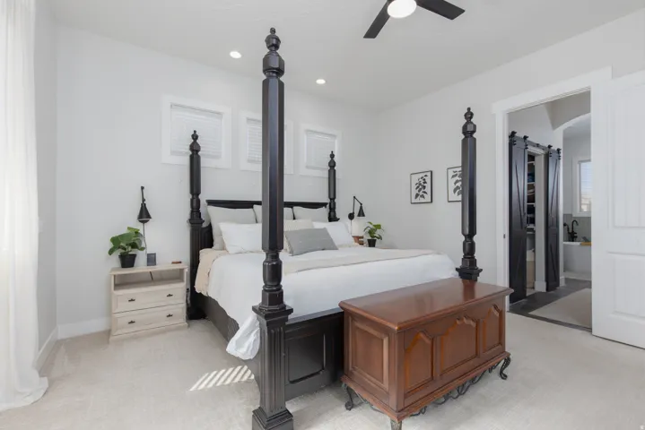 Bedroom with light colored carpet, a ceiling fan, and recessed lighting