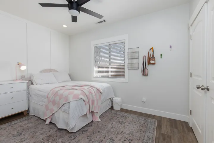 Bedroom with recessed lighting, dark wood-type flooring, a ceiling fan, and a closet