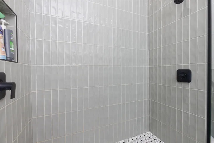 Full bath with a tile shower