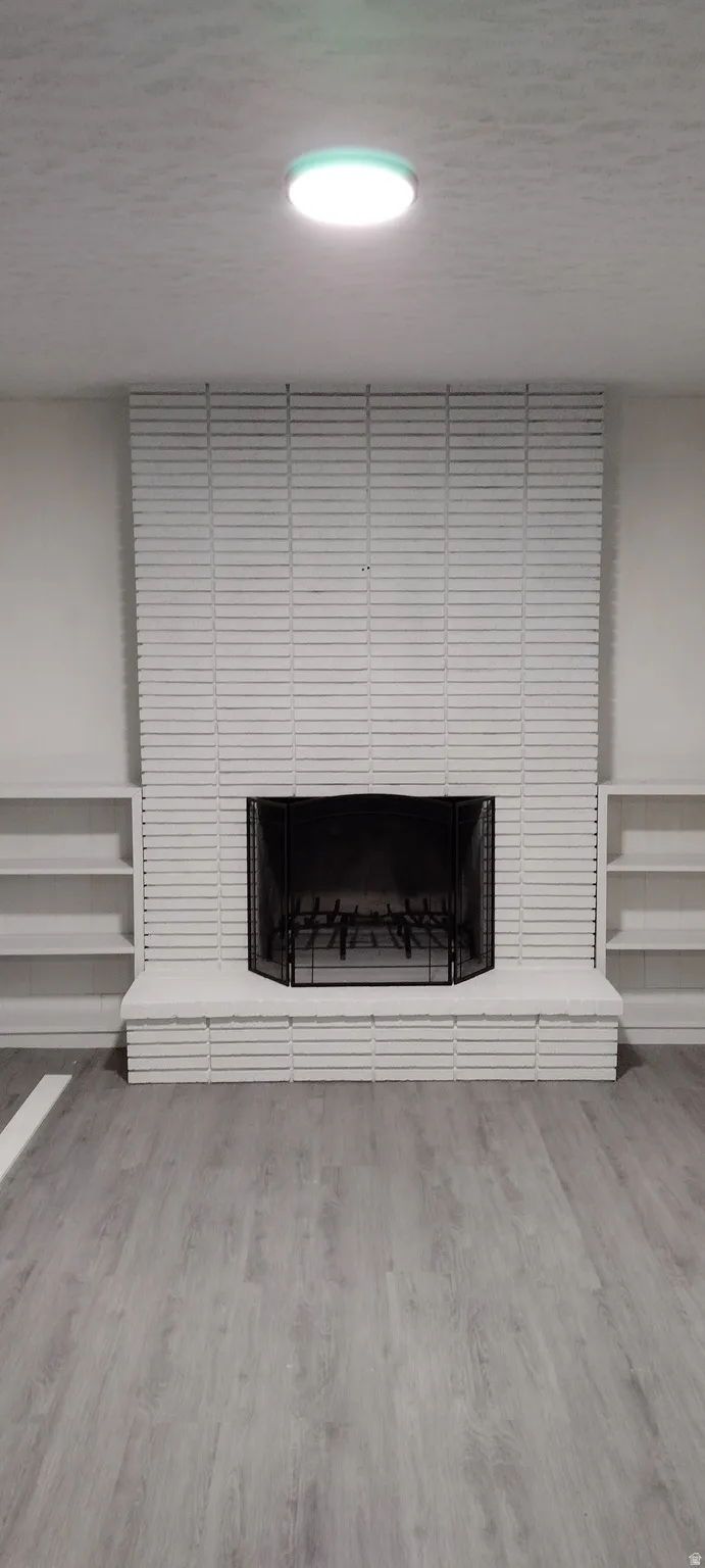 Detailed view of a brick fireplace and finished floors