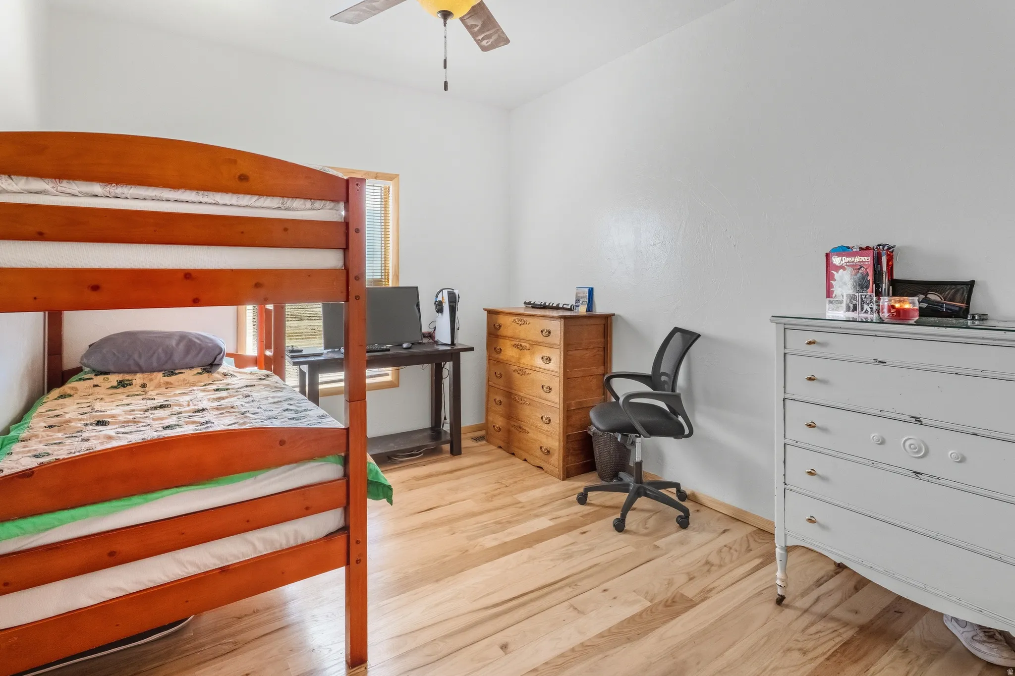 Bedroom featuring light wood-type flooring and a ceiling fan