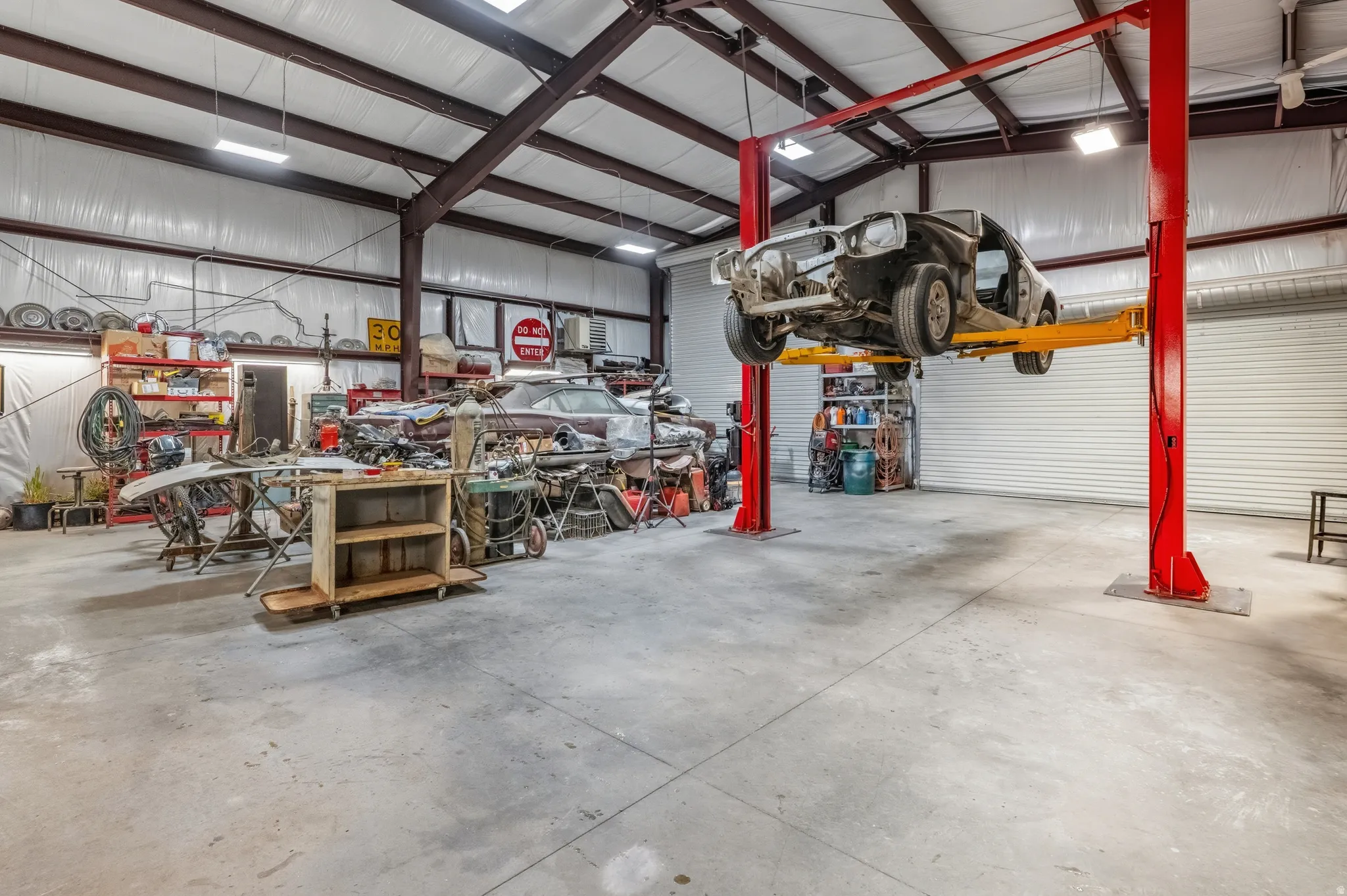 Garage featuring a workshop area and metal wall
