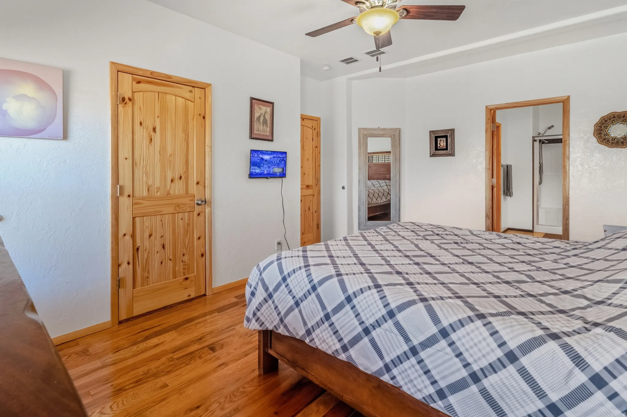 Bedroom with light wood-style flooring and ceiling fan