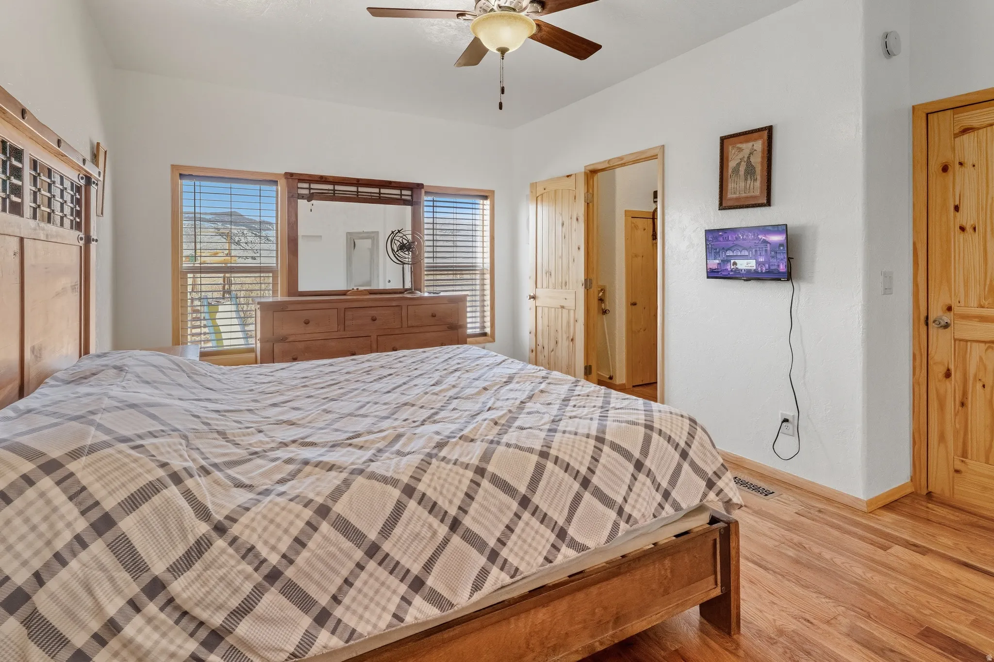 Bedroom with wood finished floors and ceiling fan