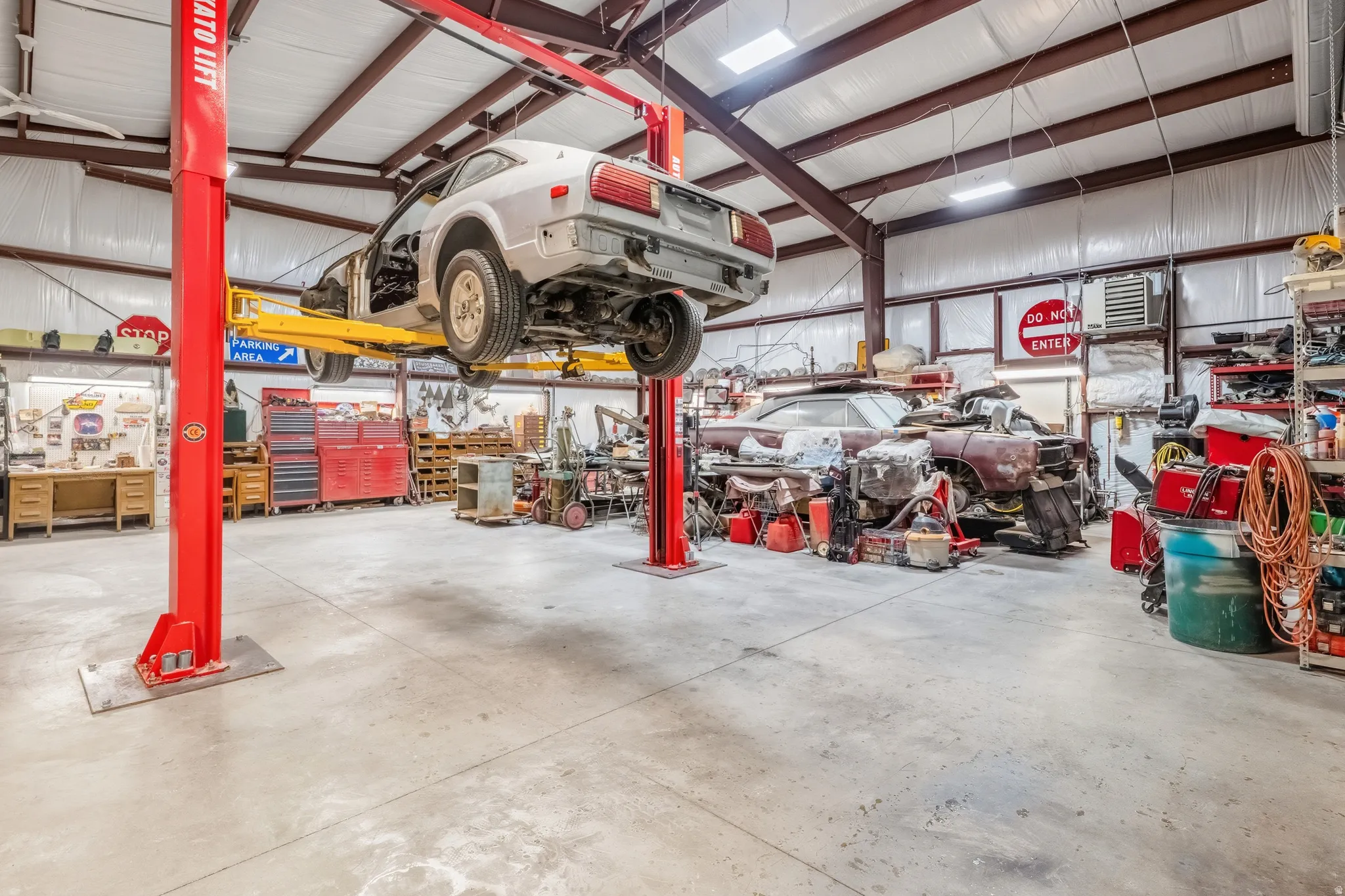 Garage featuring a heating unit and metal wall