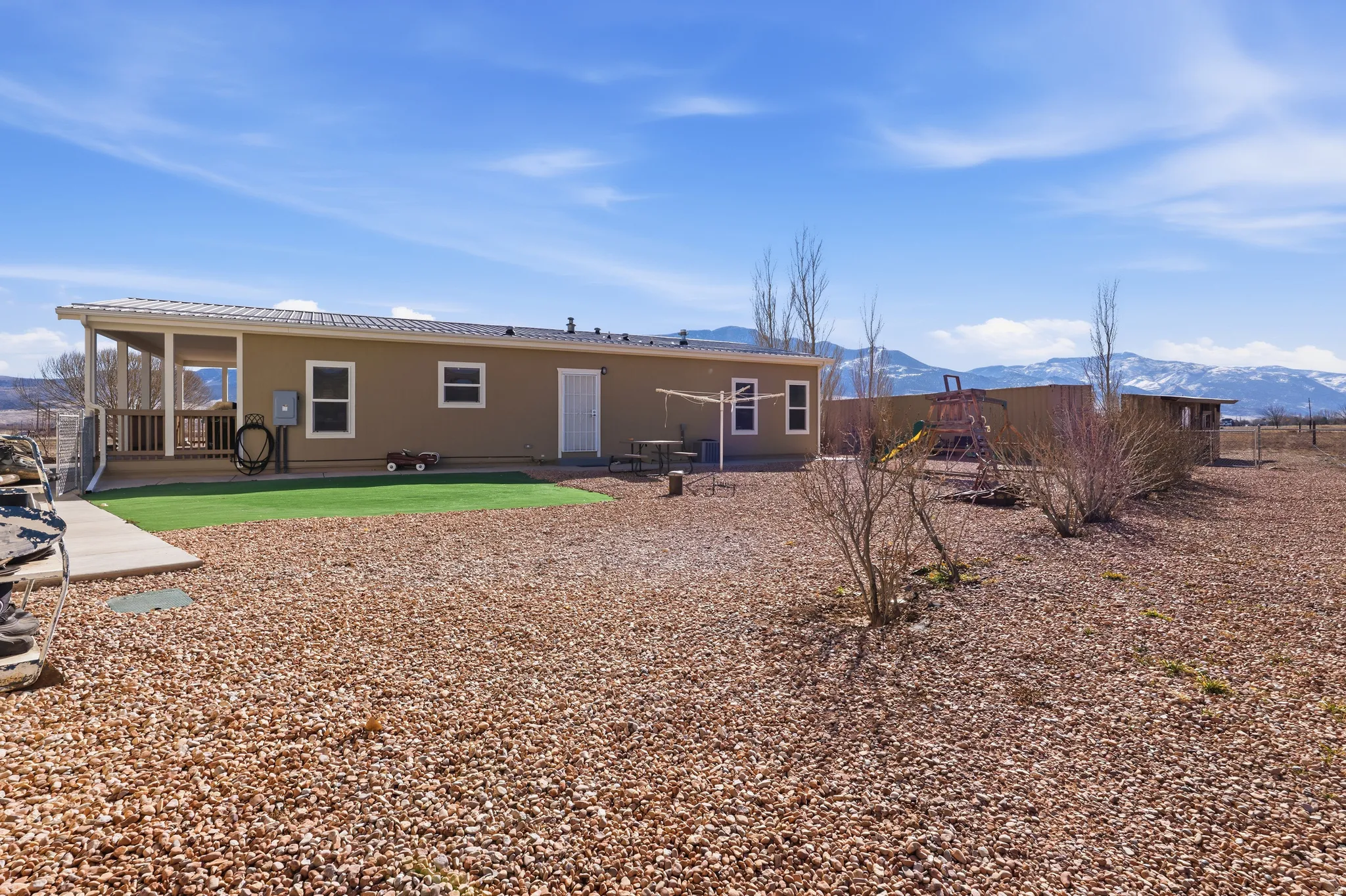 Back of house with a patio area and a mountain view