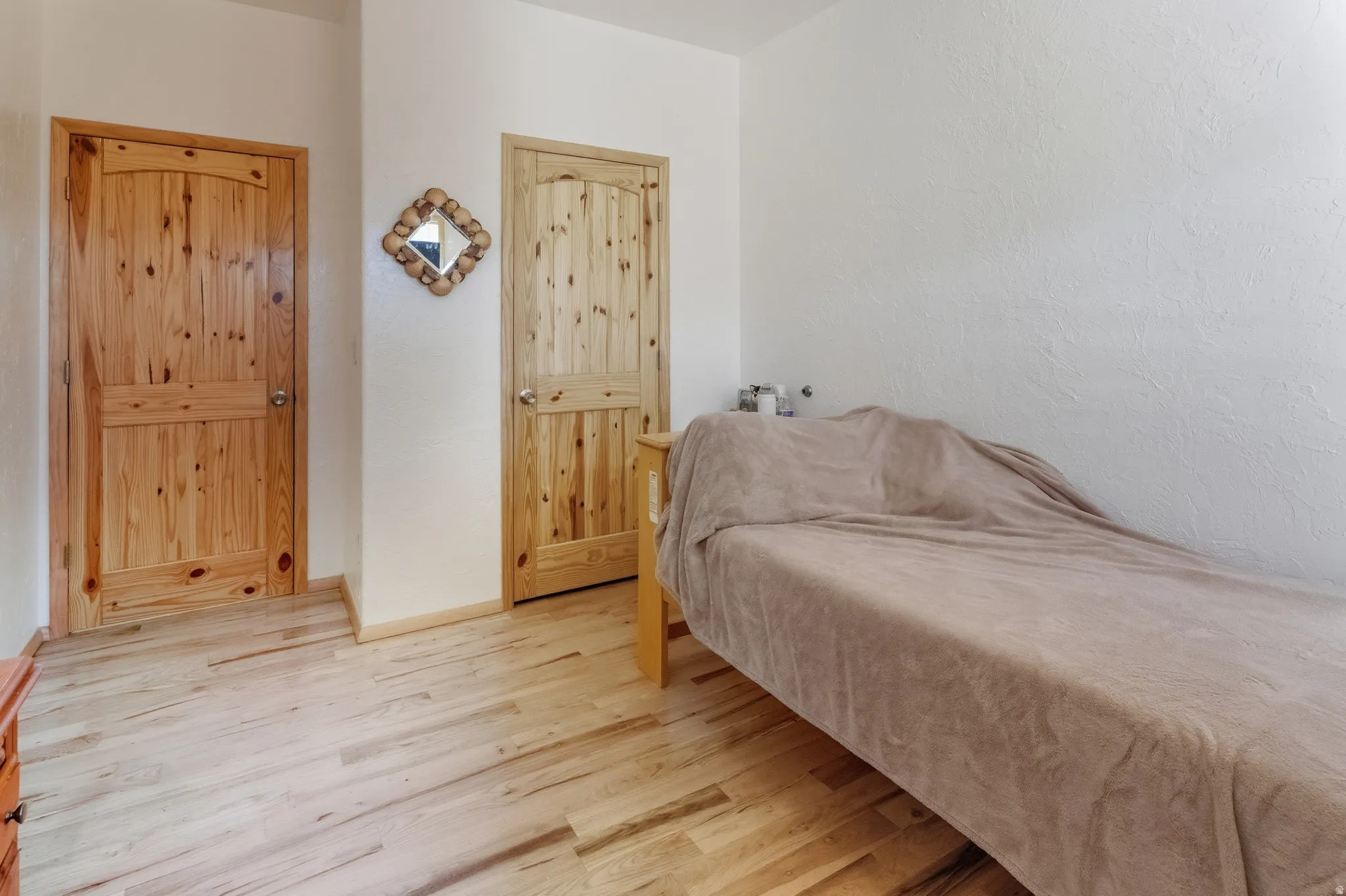 Bedroom featuring wood finished floors and baseboards