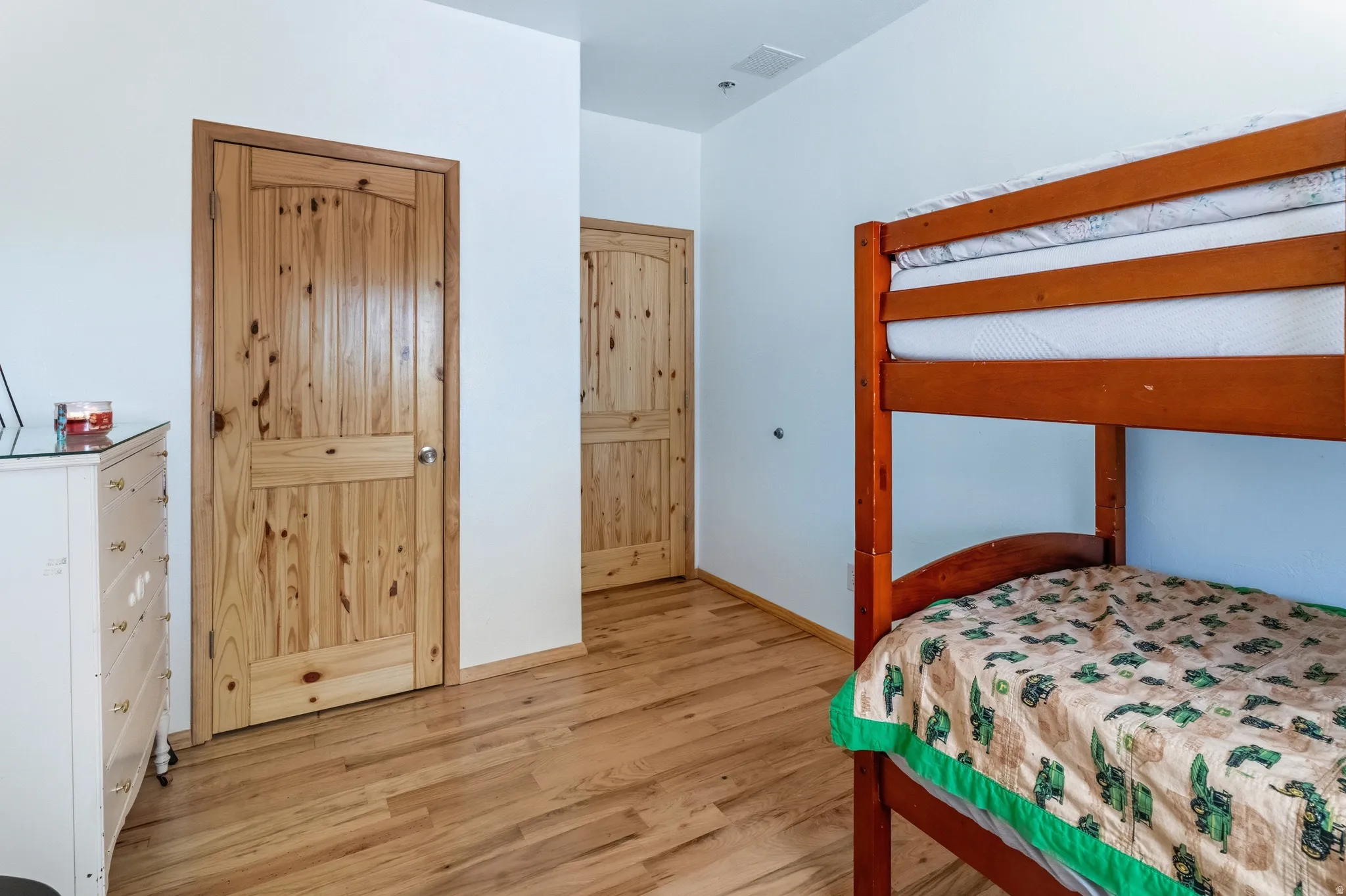 Bedroom with light wood-style floors