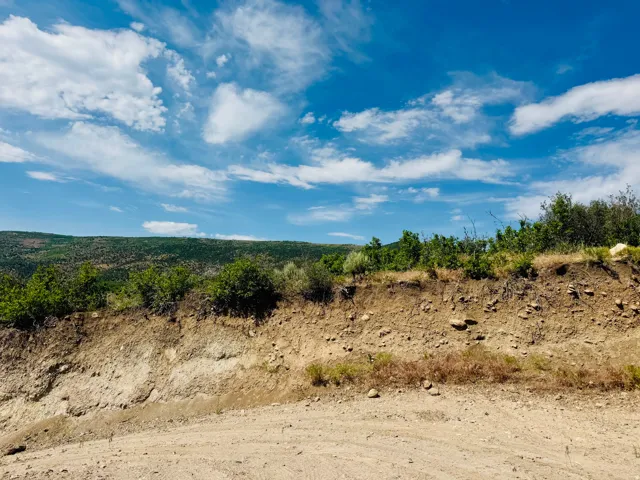 Undeveloped land featuring natural terrain and distant green hills