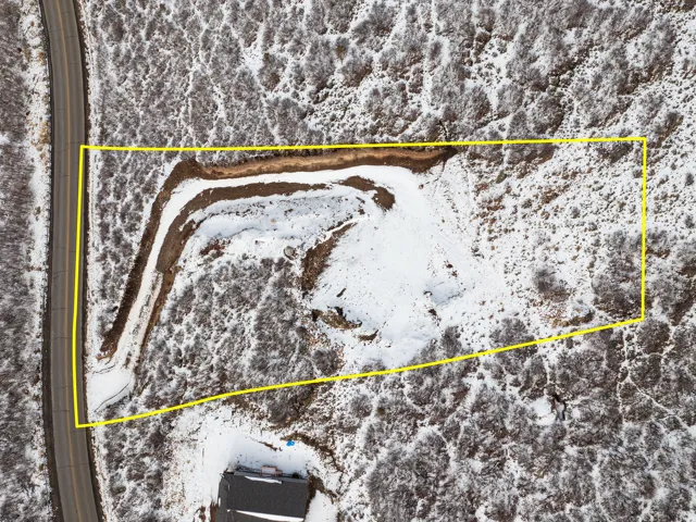 Aerial view of property and surrounding area featuring property boundaries highlighted