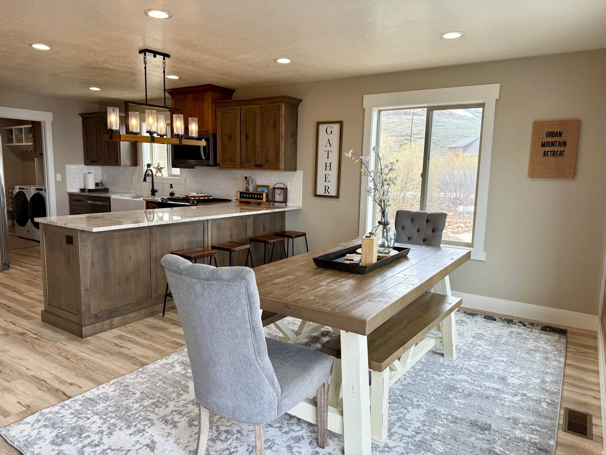 Dining room featuring light wood-style floors, washing machine and clothes dryer, and recessed lighting