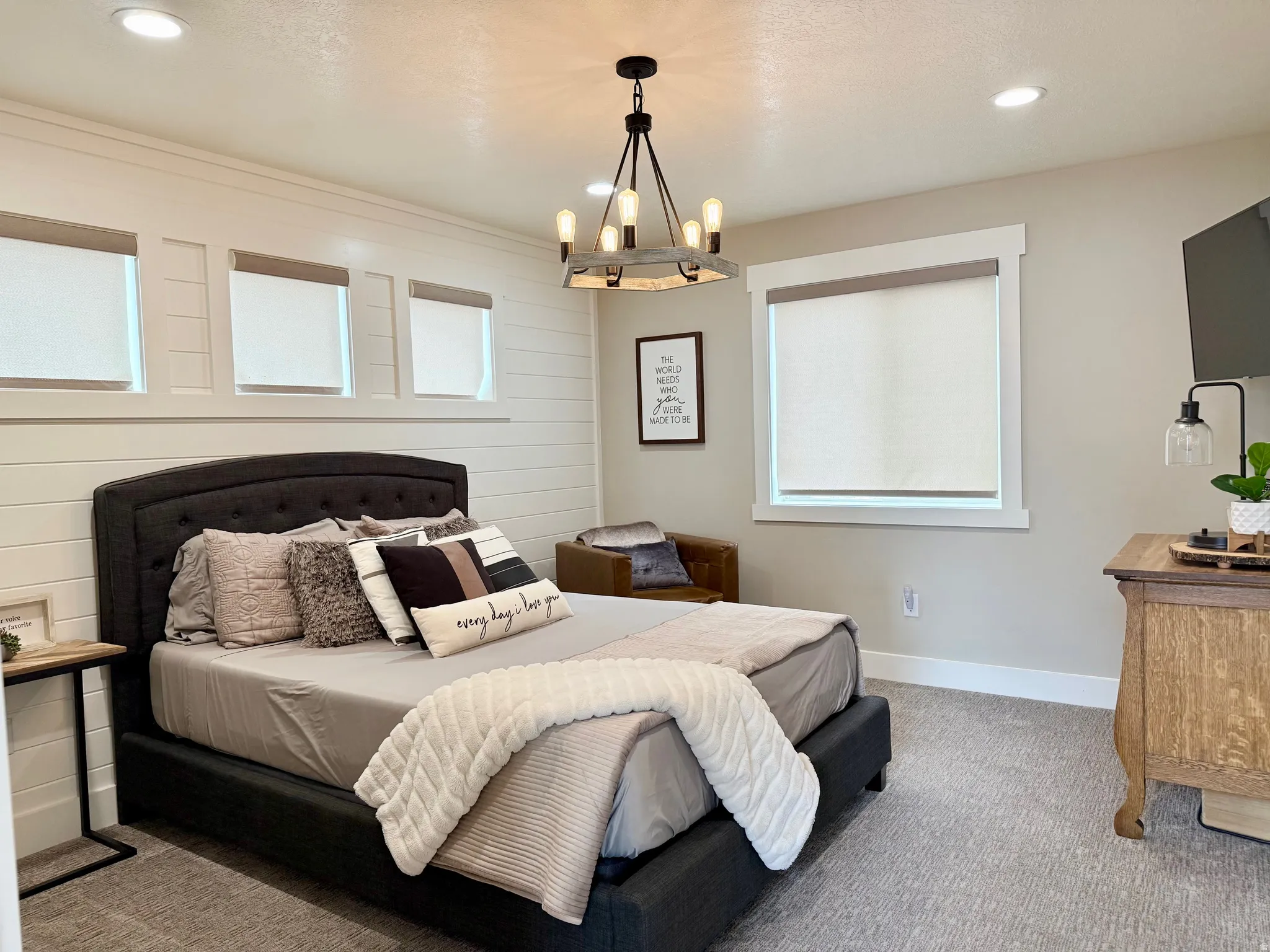 Carpeted bedroom with baseboards and hanging lights