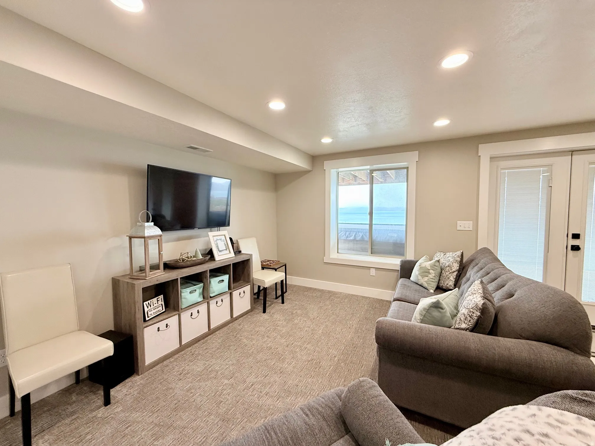 Living room featuring french doors, recessed lighting, and light colored carpet