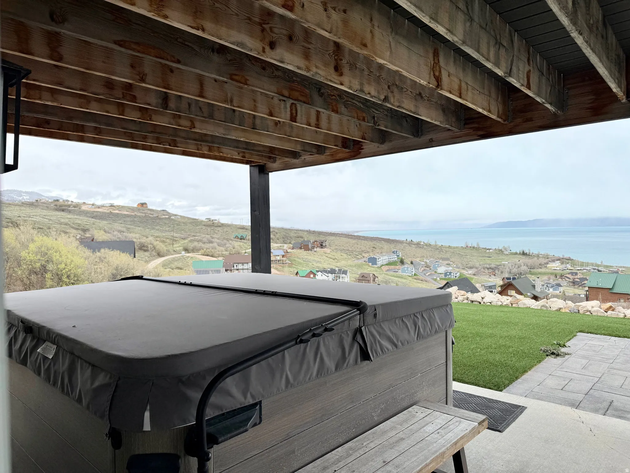 View of patio / terrace featuring a hot tub and a water view