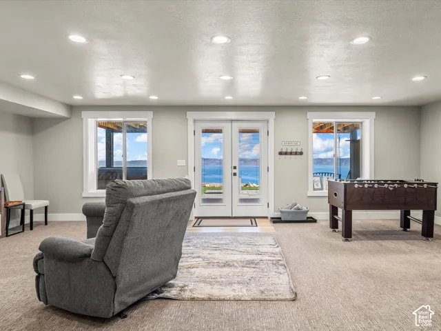 White double doors, recessed lighting, and a foosball table