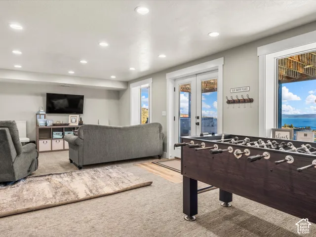 Recessed lighting, light-toned walls, and a large window with white trim