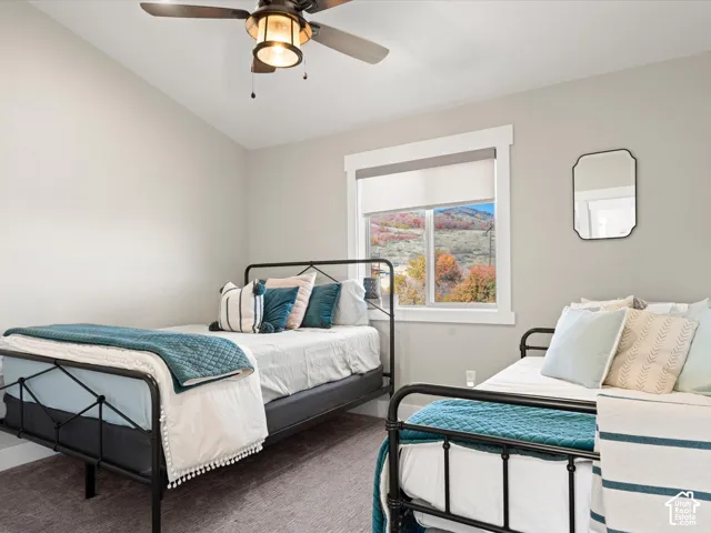 Recessed window with white trim, ceiling fan light fixture, carpeted flooring, and light-toned wall paint