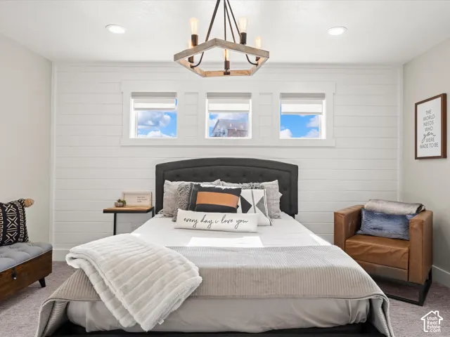 Shiplap accent wall, three transom windows, recessed lighting, and a chandelier with exposed bulbs