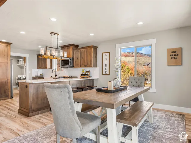 Kitchen featuring recessed lighting, wood-finish flooring, and a central island with a light-toned countertop