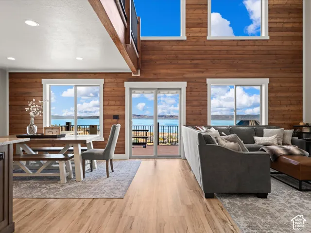 Expansive wood-paneled wall with multiple windows, recessed lighting, and wood-finish flooring