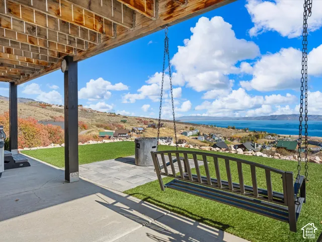 Covered concrete patio with overhead wood-beam deck structure
