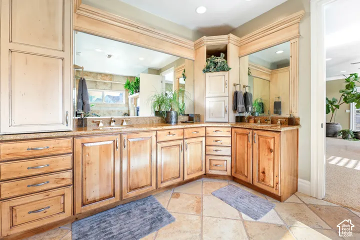 Full bathroom featuring vanity, stone tile flooring, and recessed lighting