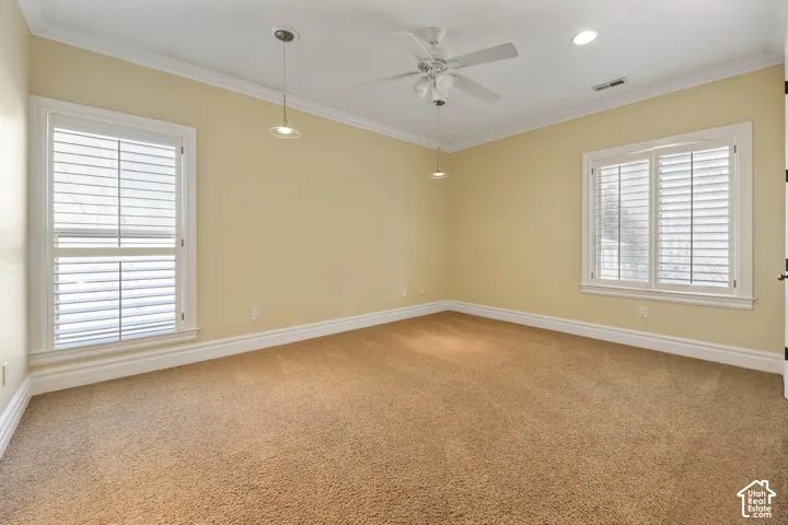 Unfurnished room featuring light carpet, ornamental molding, ceiling fan, and recessed lighting