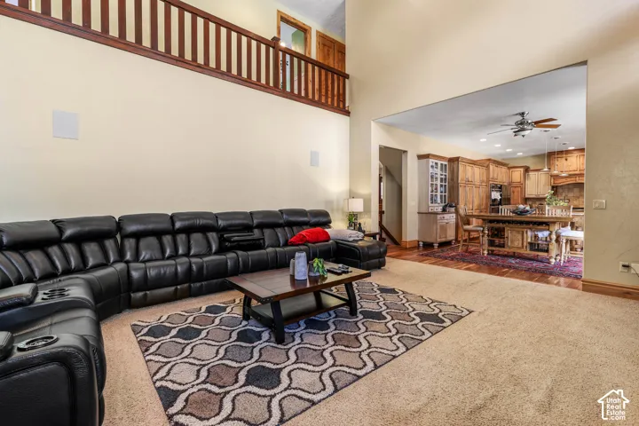 Living room with a ceiling fan and recessed lighting