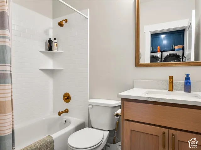 White subway tile shower surround with gold-finish fixtures and corner shelving