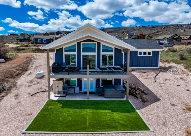Rear view of property featuring a residential view, a patio, and board and batten siding