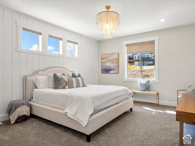 Board and batten accent wall, recessed lighting, and a decorative chandelier