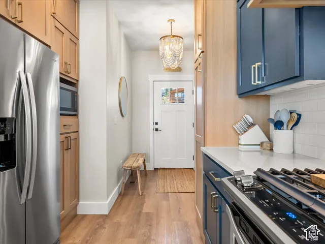 Stainless steel refrigerator and microwave built into custom cabinetry